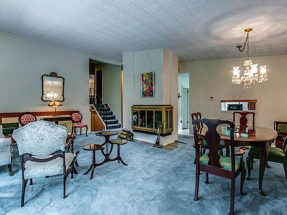 Open living and dining rooms share a fireplace