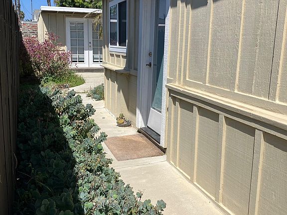 view of walkway to front door of unit A at rear of building
