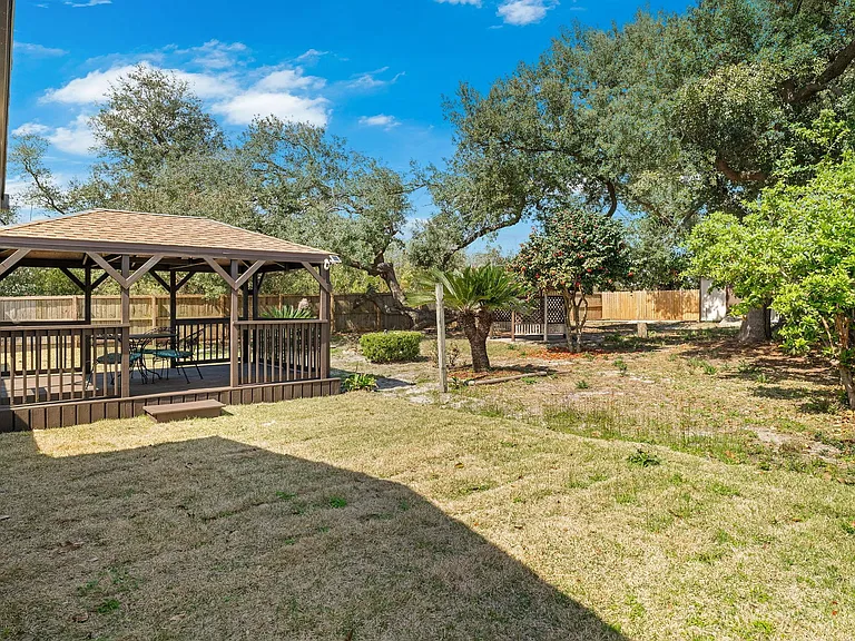 Large, private, fenced back yard with beautiful, old trees.