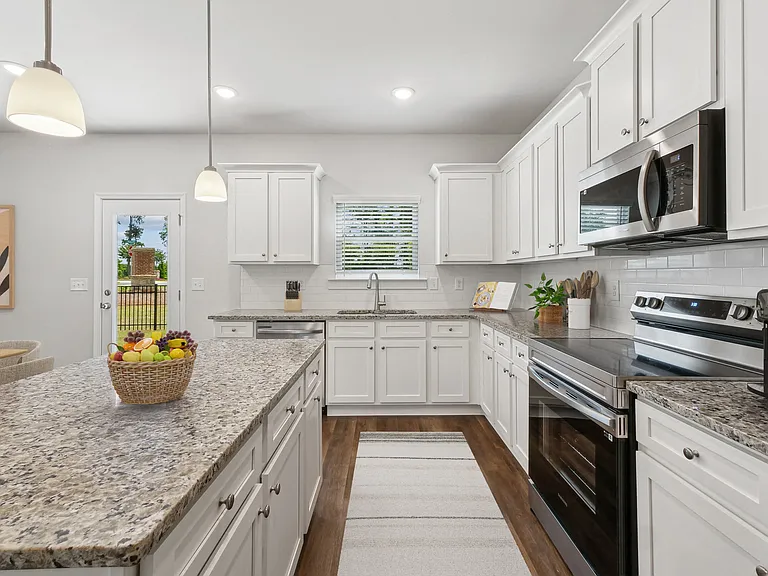 A view of the spacious kitchen and stainless steel appliances