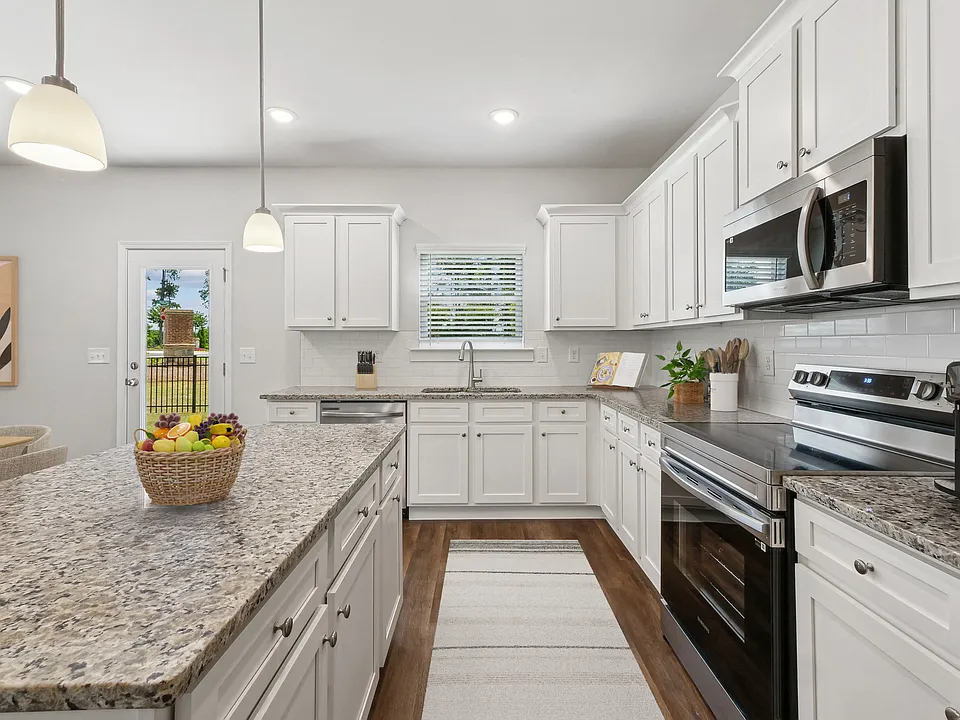 A view of the spacious kitchen and stainless steel appliances