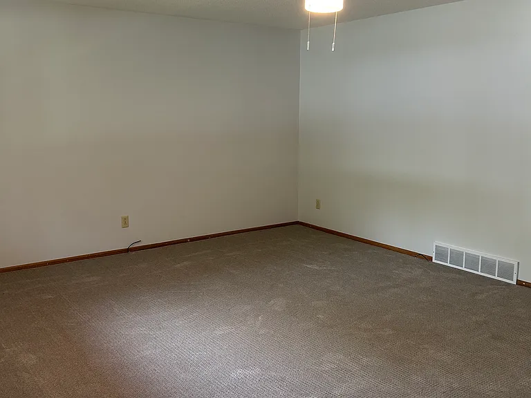 Another view of the living room from the front door, all new carpet and paint
