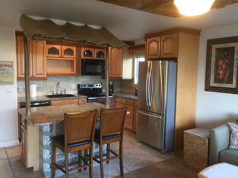 Kitchen and full-size refrigerator.
