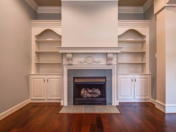 Front formal living room with fireplace and beautiful adjustable shelving.  Fantastic crown molding and cabinetry.