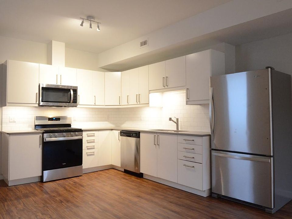 Well-appointed open kitchen. (quartz counters, subway tile back splash, stainless steel appliances)