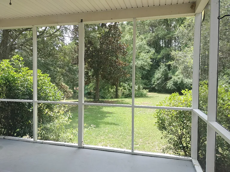 Screen porch overlooking a large backyard