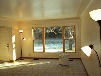 Large living room with newer carpeting. The are hardwood floors under the carpet.