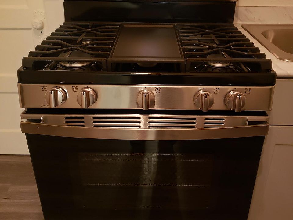 New 5 burner range with griddle top middle.