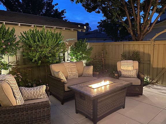 Outdoor furniture and fire pit included! Come relax in this cozy courtyard.