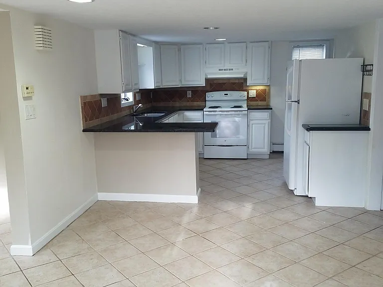 Kitchen with seating for two at end of counter