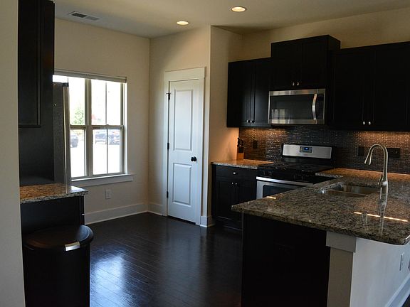 Kitchen with cabinet space and built-in under the counter LED lights. Pantry in the corner.