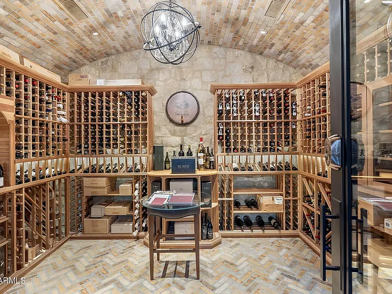 Private wine cellar adds a distinctive luxury touch to the home's impressive amenities.