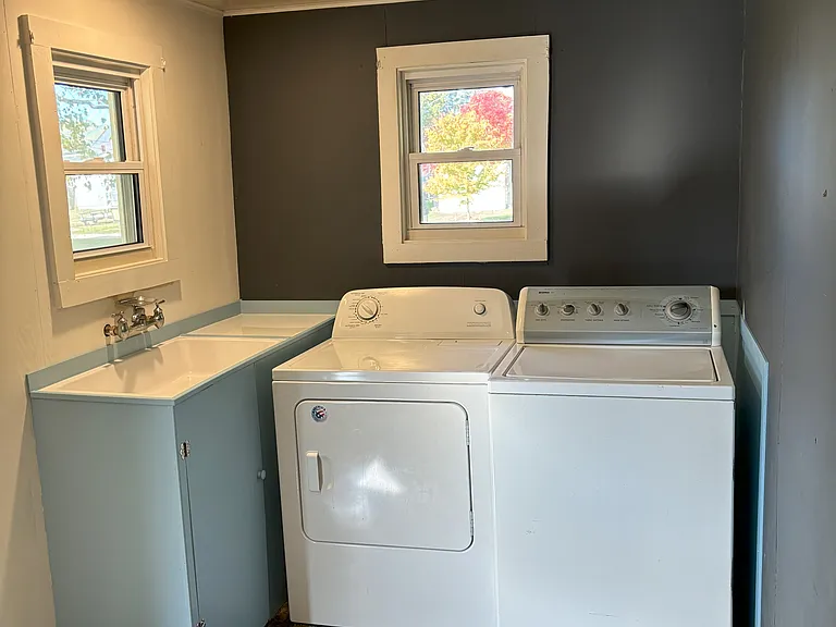 Laundry Room complete with washer, dryer, and sink