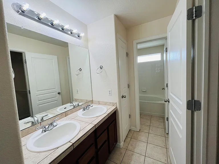 Beautiful spacious master bedroom with vaulted ceilings, large windows, large walk-in closet with custom shelving. Master bathroom with his and her sinks, spacious bathtub, linen closet