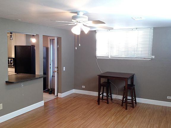 View from front door into living room and kitchen door and passthrough which has bar seating.