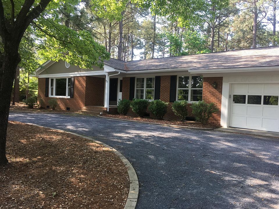 Front of home with a circular driveway