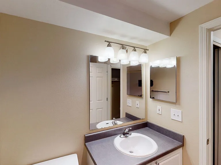 Apartment bathroom with tile flooring.