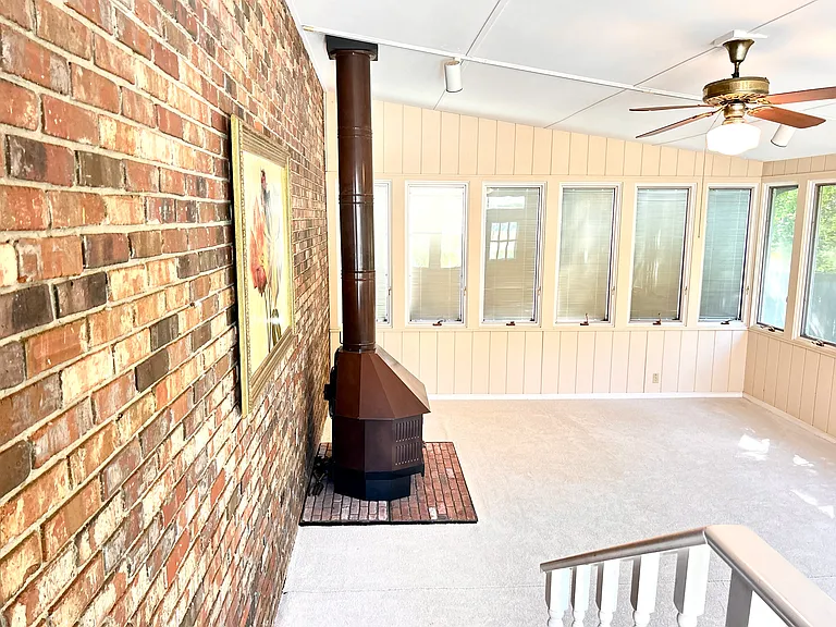 The huge bright sunroom where you sit and relax and have view to the backyard, patio in the back. You enjoy the separate wood burning heater and AC in the sunroom.