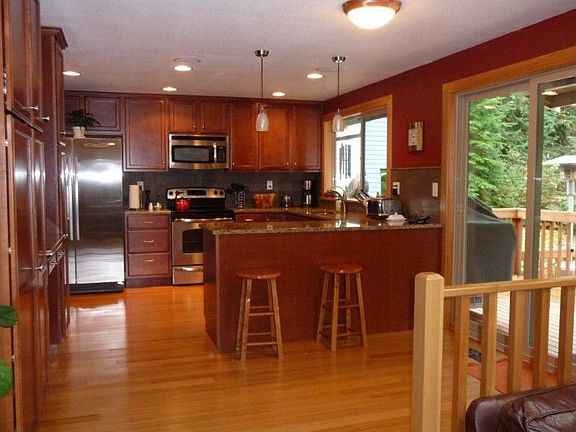 More kitchen detail. Note the stainless appliances, hardwood floors and granite counters.