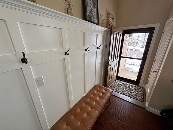 Front door with storm door and hall tree.