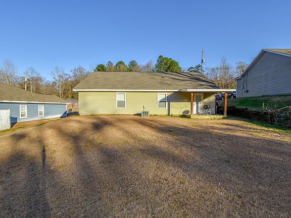 Image 4: Back of home with a huge back yard