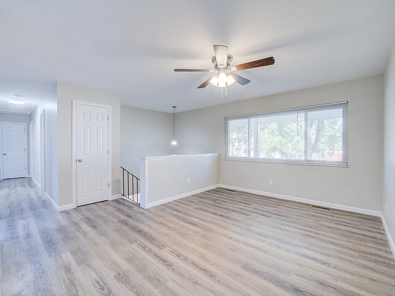 Living room area as you walk upstairs from front door. New flooring, doors, and paint.