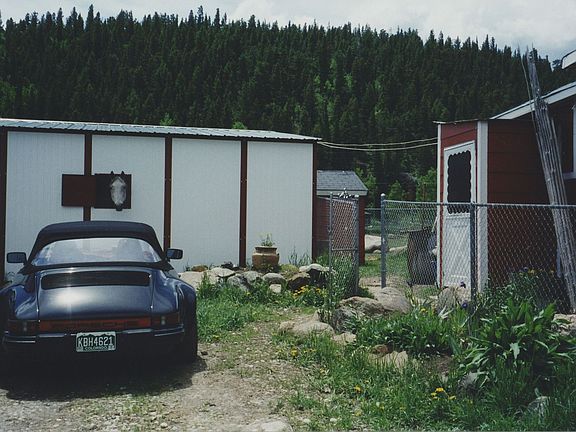 White Barn on left; red House on right; Porsche not included