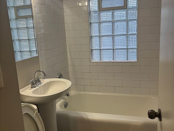Bathroom with subway tile tub surround.