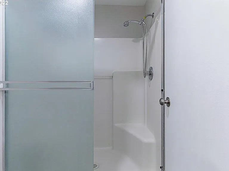 Master bedroom bath - Glass door has been replaced with weighted shower screen for more room and ease