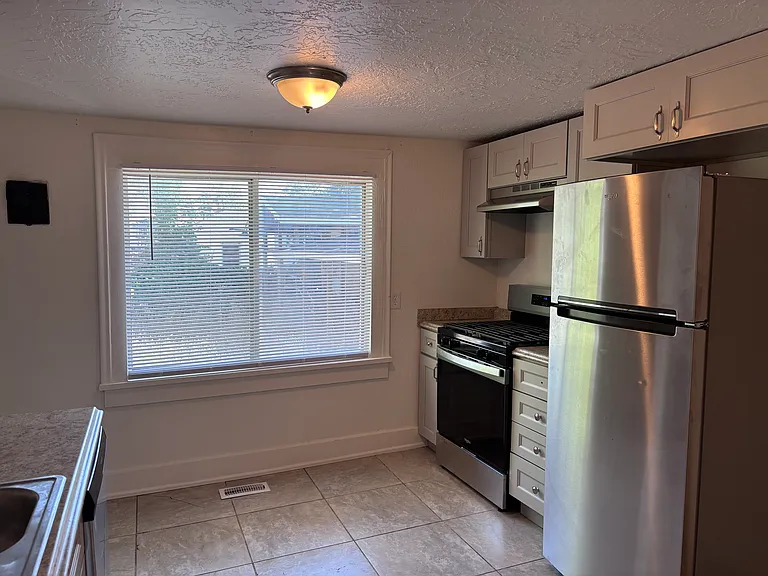 New stainless refrigerator and gas stove