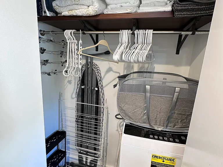 Closet with apartment size washing machine that connects to the bathroom sink for use (very easy to use!)