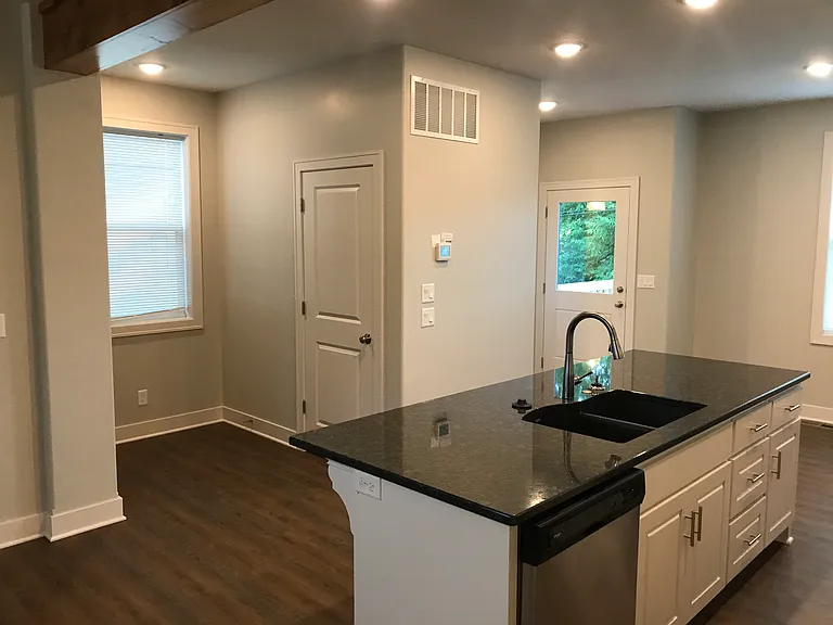 Entry closet, back door to deck, powder bath and pantry to left of back door