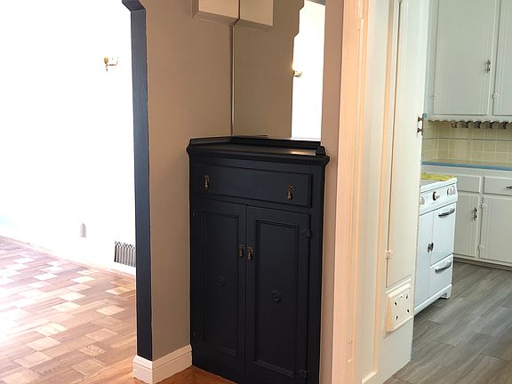 View of built-in bar in dining room with living room to the left and kitchen to the right.