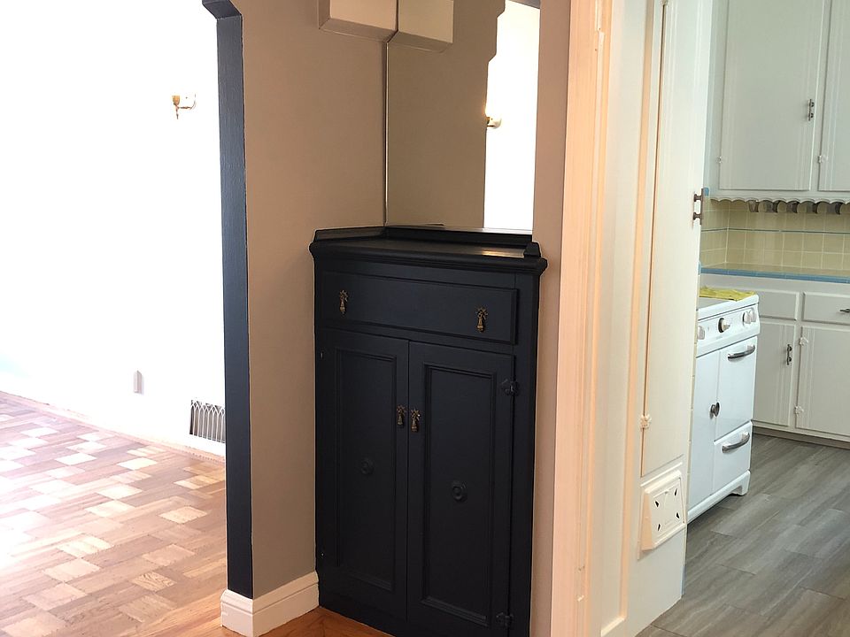 View of built-in bar in dining room with living room to the left and kitchen to the right.