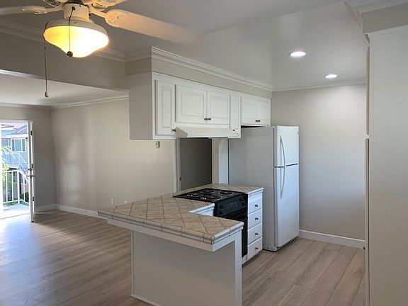 Kitchen, Living Area, and Hall entry seen from Dining Area