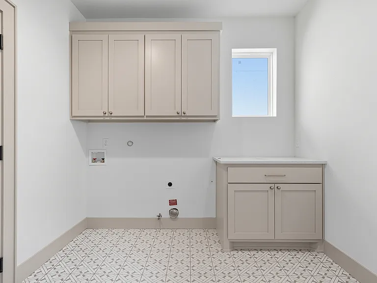Dedicated laundry room with built-in mudbench and storage.