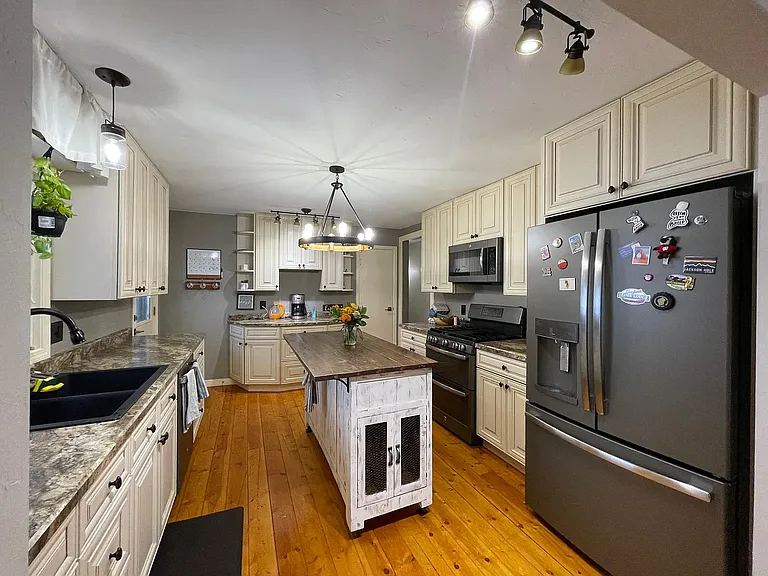 Beautifully updated kitchen with plenty of cabinet space and a pantry.