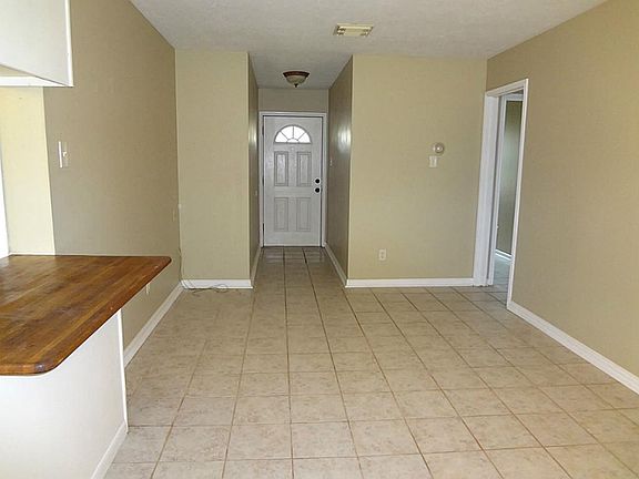 All new tile floor throughout. View of front entrance and open living area