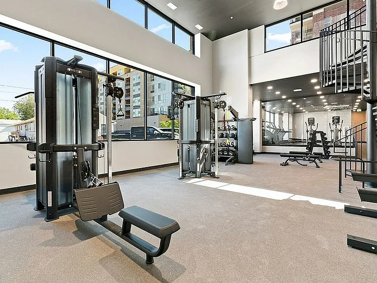 Two Story Fitness Center with Spin Bikes, Free Weights, Cardio Machines, and Strength-Training Machines
