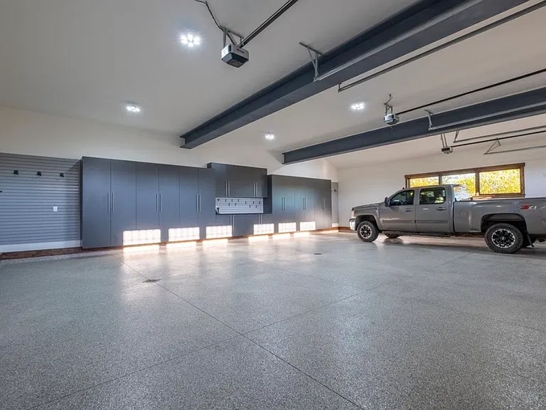 Massive overside 3 car heated garage. Custom cabinetry, EV charger, 220V charger, custom ski racks, bike racks, etc.