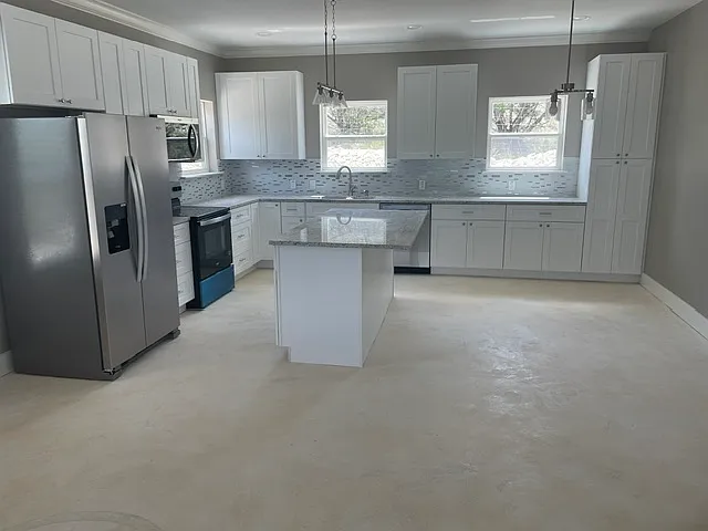 Refrigerator included, granite topped island, plenty of cabinets. Space for a kitchen table and bar stools.