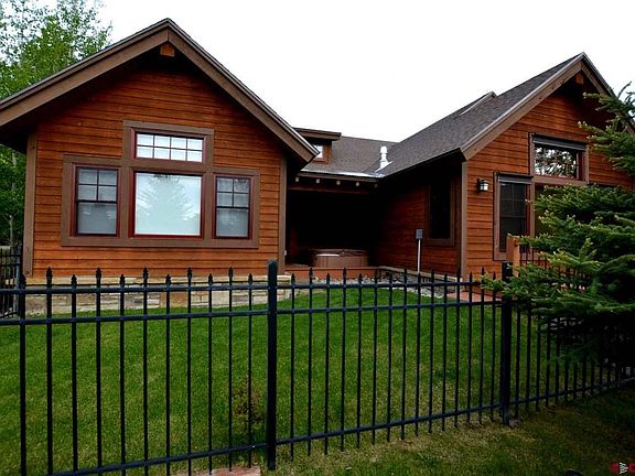 Fenced in back yard and hot tub alcove.