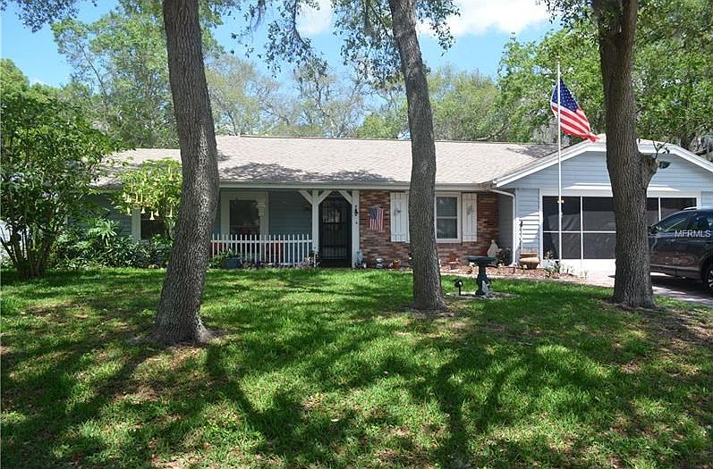 Front of home - large front lawn with mature landscaping