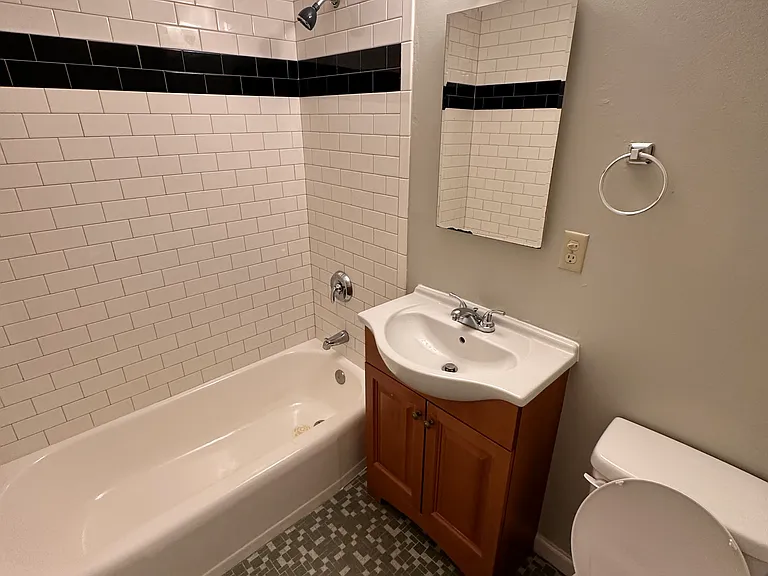Bathroom with tiles floor and tiles tub surround