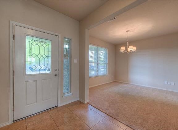 A foyer and a formal dining room!  Recent light fixture and carpet!
