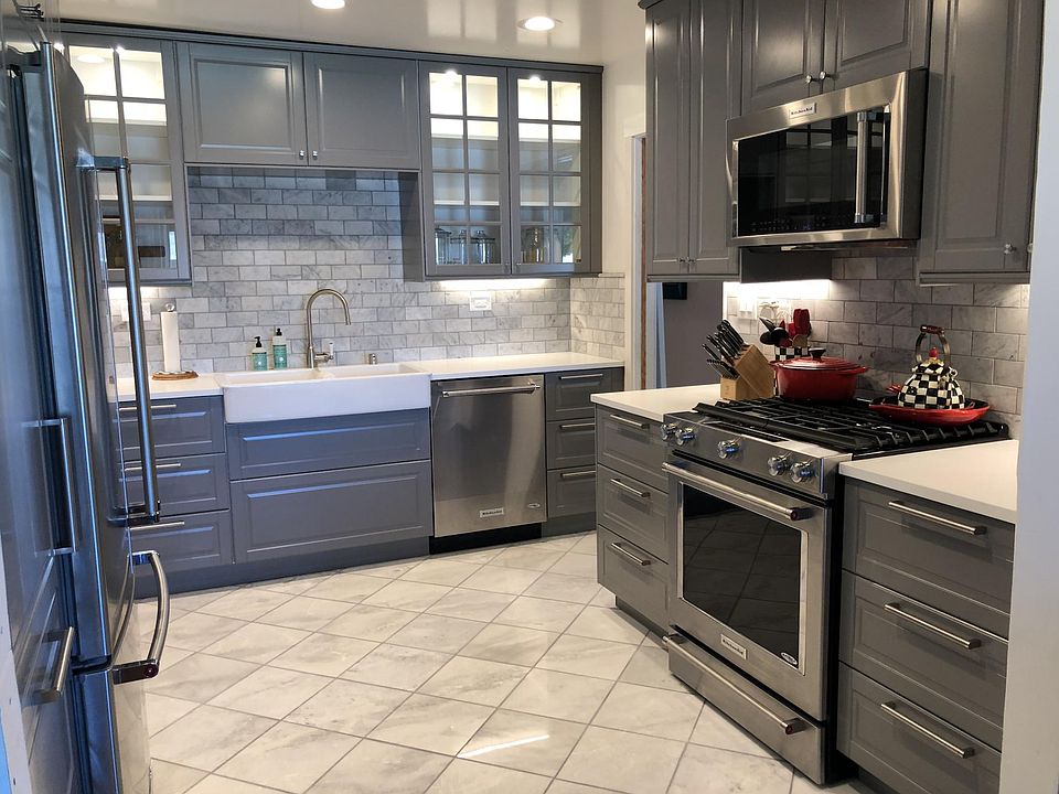 Remodeled high end kitchen - Marble Floors, Kitchen Aid stainless steel appliances, farmer double sink, stone counters, marble backsplash, new cabinets with interior lighting, new ceiling recessed lighting.