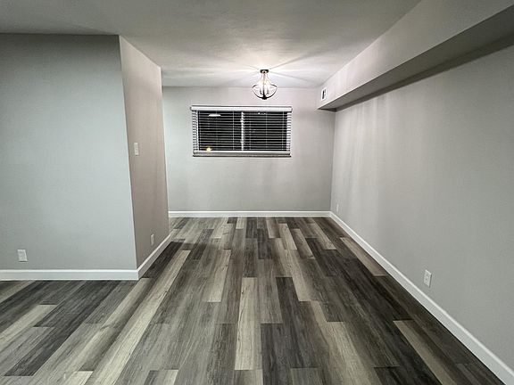 This is standing in front of the in-unit laundry looking at the living room & dining room.