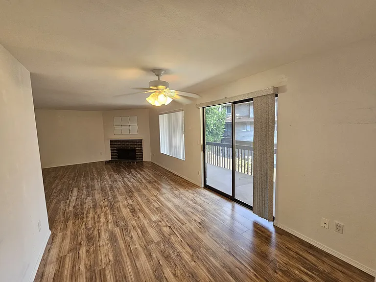 Light and bright open concept living room with access to deck
