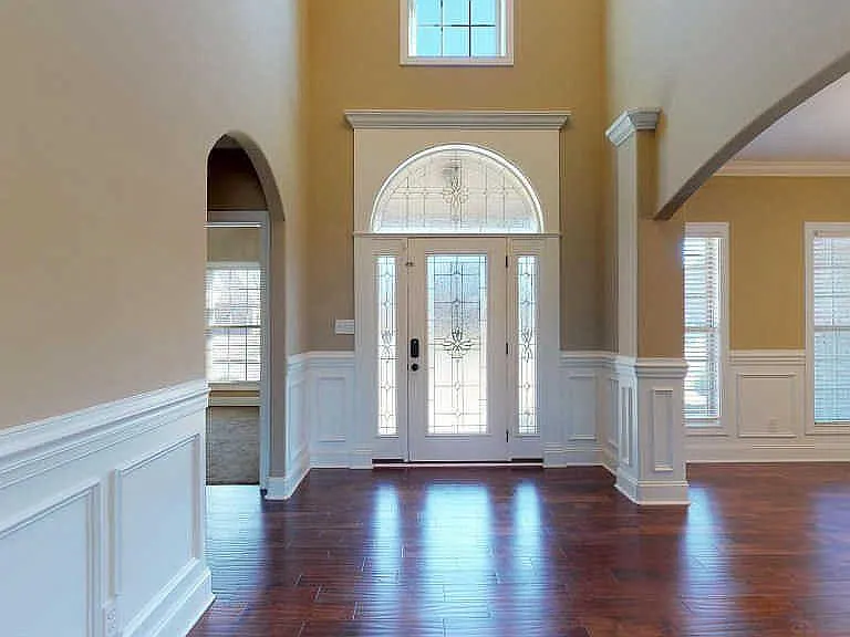 Grand two story foyer with soaring vaulted ceilings