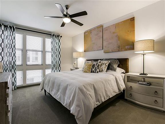 Master Bedroom with plush carpet and ceiling fan.